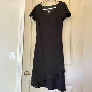 Black Special Occasion Dress with decorative shiny stone detail on bottom.